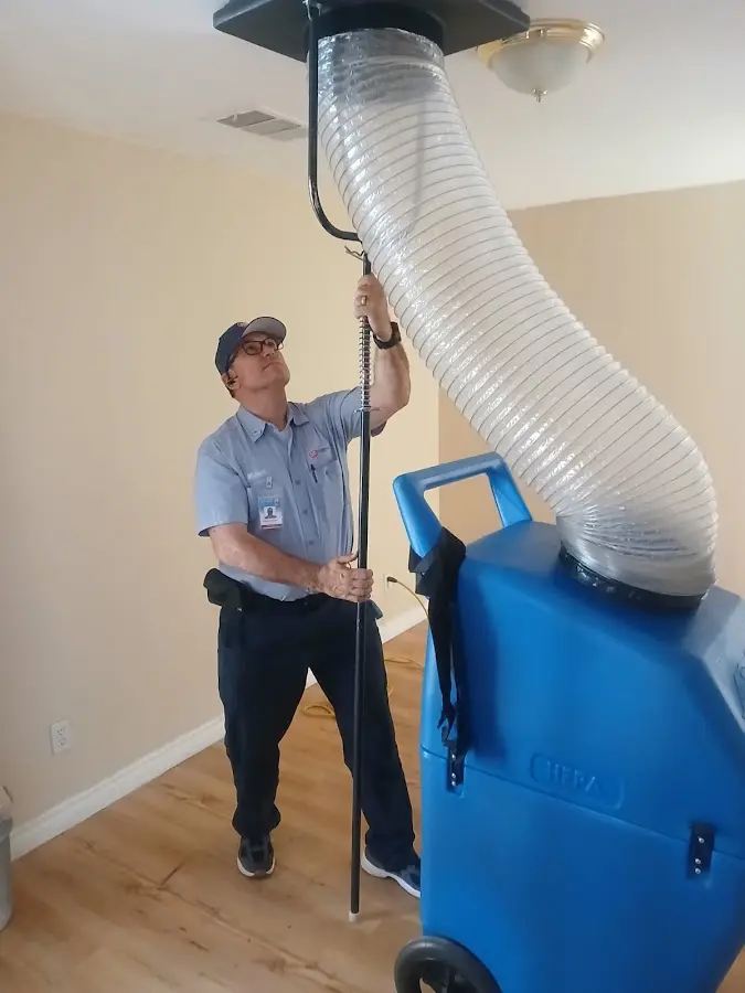 Furnace Tune-Up technician using HEPA equipment in North Weeki Wachee