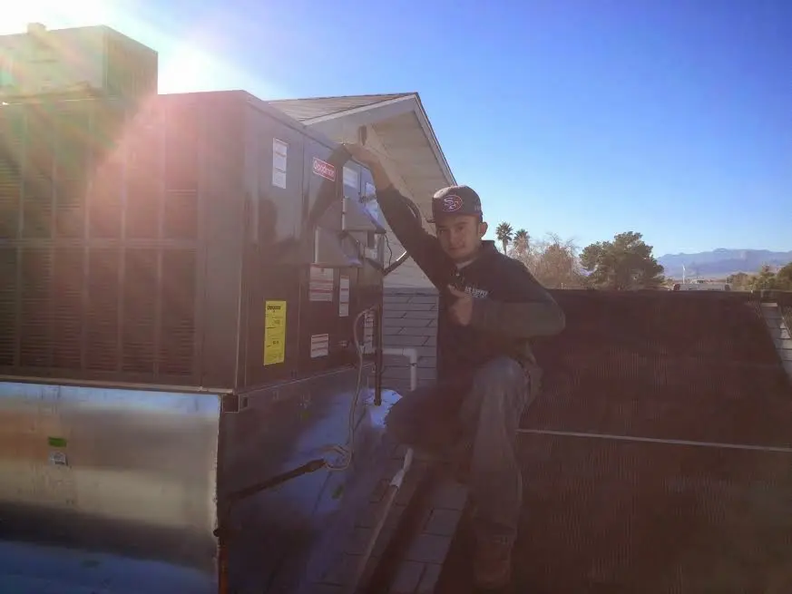 HVAC technician performing Boiler Repair on a rooftop unit in North Weeki Wachee